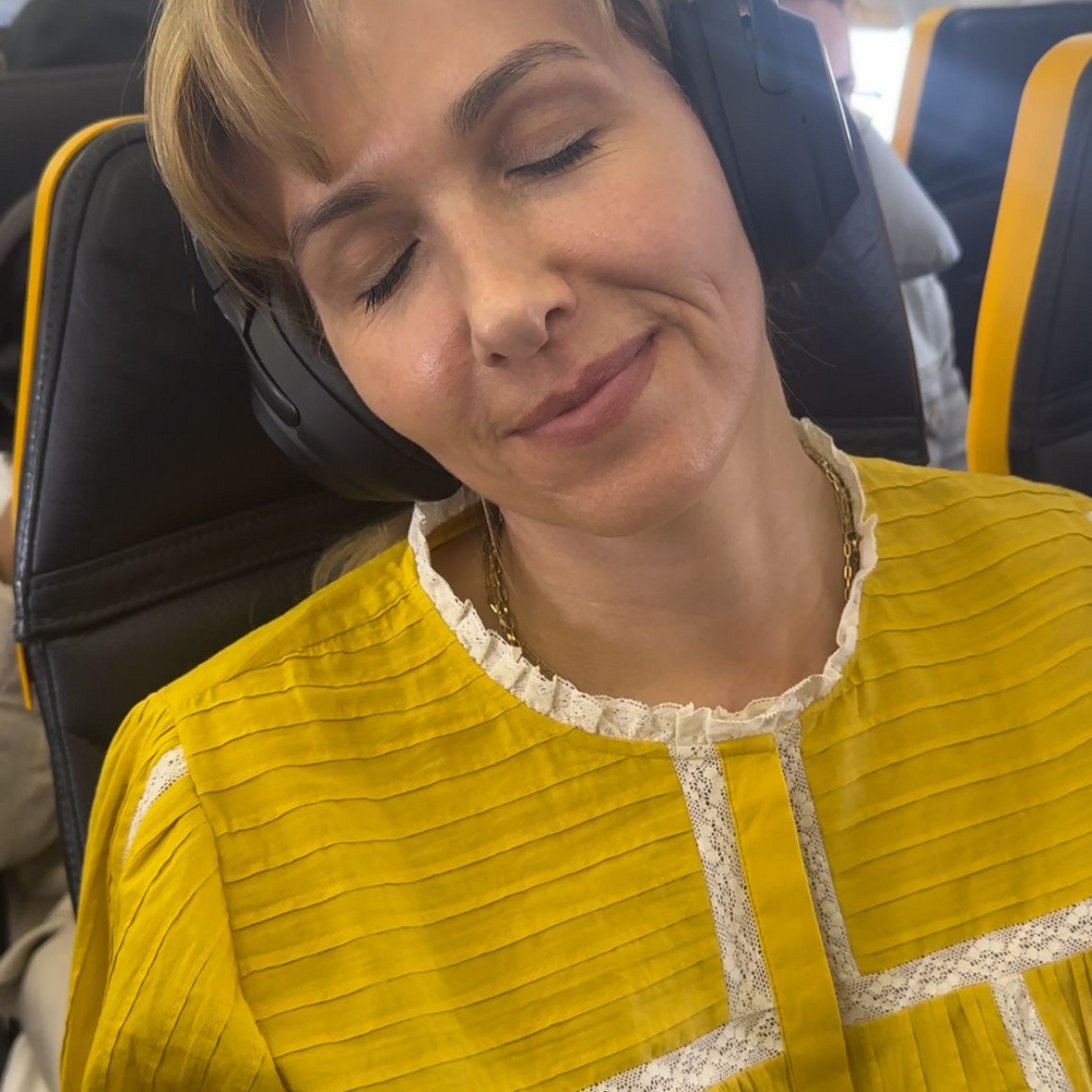 woman asleep on a plane relaxing 